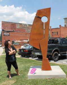 Regina Jilton of Gray peruses sculptor Kyle Lusk's "Diversion," the first of 15 works to be installed downtown and in the downtown/ETSU corridor. Photo by Jeff Keeling