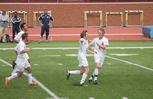 Senior Max Vaughn, right, congratulates John Huffman after Huffman scored the Toppers' third goal. (Photo by Jeff Keeling)
