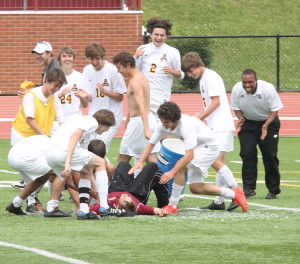 Science Hill players mob coach Brandon Kind after the proverbial water cooler shower. (Photo by Jeff Keeling)