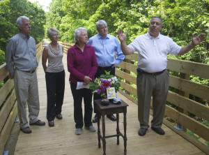 Dr. Dan Schumaier of the Rails to Trails committee speaks at a new bridge over Buffalo Creek near Elizabethton as City Public Works Director Phil Pindzola, Katie Pindzola, City Commissioner Jenny Brock and fellow committee member Ray Flynn look on. Photo by Scott Robertson.