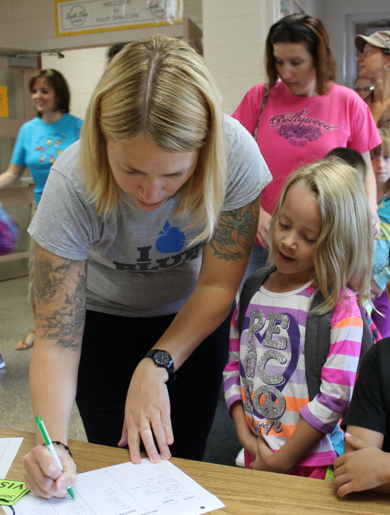 Janet Williams registers her daughter, Ella Lucas, for first grade.
