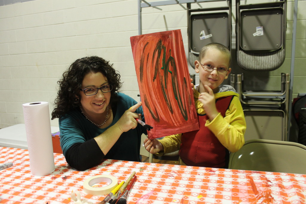 Lisa Hensley and Jimmy Johnson with a work of art produced at the Boones Creek Christian Church ARC respite site. (Photo by Jeff Keeling)