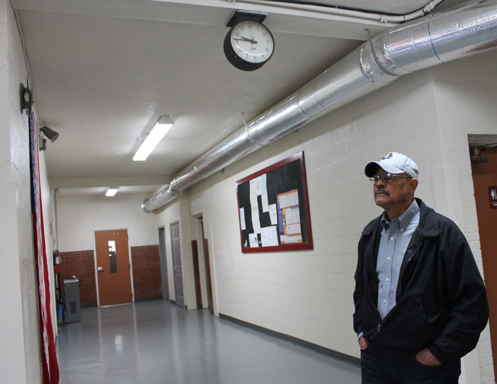Angelo Newman Jr., a member of Langston's final graduating class (1965), reflects in a hallway of the long-closed school.