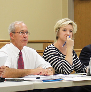 Baker and commission veteran Joe Grandy listen during one of Baker’s first commission meetings. Photo by Jeff Keeling