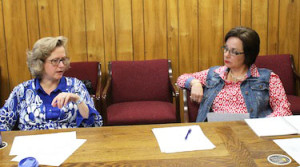School board members Kathy Hall, left, and Lottie Ryans converse during an efficiency committee meeting Monday.