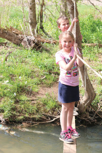Kaitlynn and Kelton Cupples navigate the park’s current stream crossing, which will be replaced by a bridge.