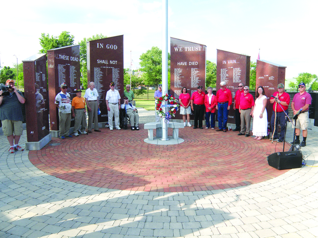 The Johnson City/Washington County Veteran’s Memorial was the scene of the annual service honoring local military veterans who have fallen in battle. Family members, friends and fellow veterans stand in front of the monuments. Photos by Bill Derby