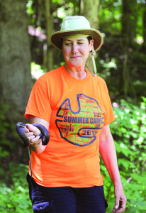 Naturalist Connie Deegan tells “Habitat Explorers” camp participants about the habits of the black rat snake she’s just caught at Jacob’s Nature Park at Sinking Creek.
