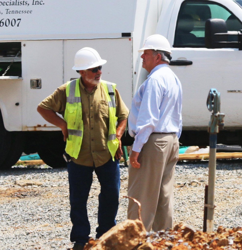 Tommy Burleson, right, the owner’s agent for the City of Johnson City, discusses progress Monday with a representative from Trademark of Virginia.