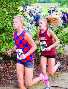 Science Hill junior Halle Hausman battles with a Riverside (S.C.) runner on her way to a fourth-place finish at the Eye Opener meet. Photo by Cora Wymer.
