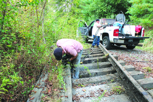 A two-man crew from Michigan salvages one of the last sections of rail, near Greenlee Road, on Oct. 13, 2013.