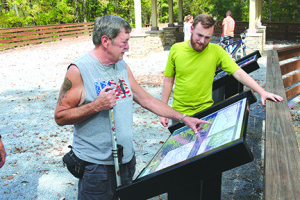 Logan Hester, right, looks as Ken Moore points to a graph showing the various elevations traversed by the East Tennessee and Western North Carolina (Tweetsie) rail line.