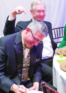 Mountain States Health Alliance CEO Alan Levine, left, prepares something very, very important under the watchful gaze of Niswonger Children’s Hospital namesake Scott Niswonger during Saturday’s Mountain States Health Alliance Foundation Spirit Gala at the Millennium Centre. For a story and more photos, see page 5. Photo by David Wood