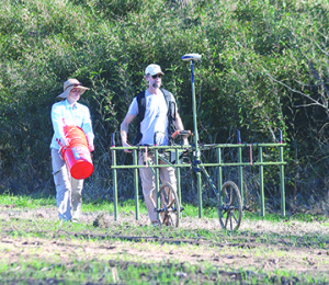Steve Jones, left, and ETSU Geosciences Professor Dr. Eileen Ernenwein use a magnetometer to plot a section of the Cane Notch site. Photo by Jeff Keeling
