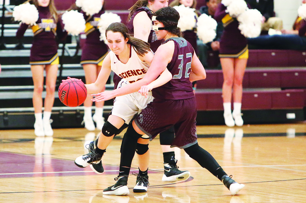 Science Hill’s Haley Rodgers works to fight her way past a masked defender.