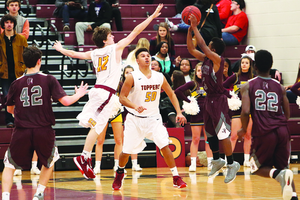 Topper Trent Martindale skies for a block attempt as teammate Nakiya Smith looks on.