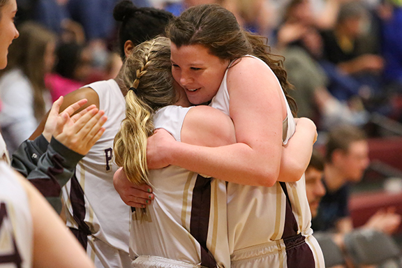 Fellow seniors Katie Schoondyke, left, and Emma Harrod share a hug before their last home game at Providence Academy -- a 54-23 rout of KACHEA.