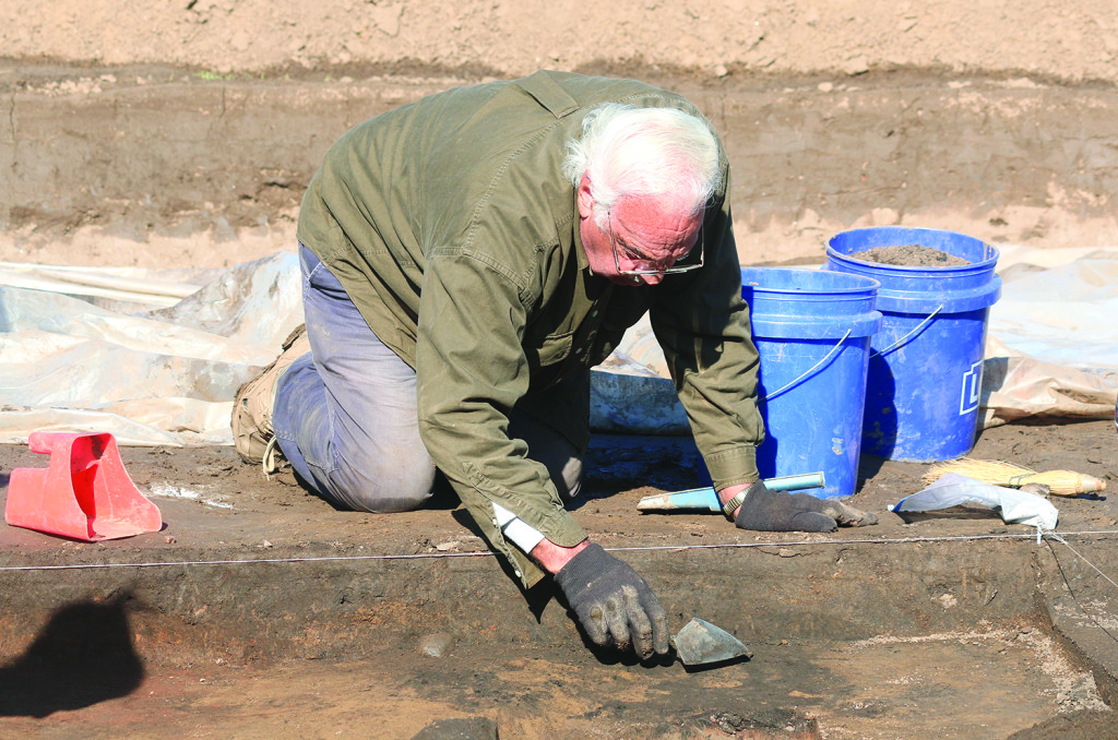 S.D. Dean works with a trowel in the proto-historic house excavation at Cane Notch. Photos by Jeff Keeling