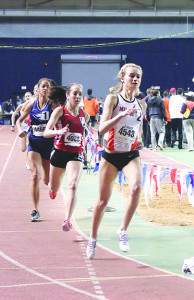 Milligan College junior Hannah Segrave, front, leads the pack midway through her qualifying run in the 800 meters Friday. Hannah Wondra of Benedictine, on Segrave’s heels here, was second in the finals but a full 4.3 seconds behind Segrave, who set a meet record. Photo by Jeff Keeling