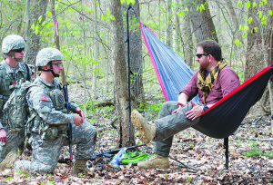 Fourteen-year Army veteran Jon Morgan, right, speaks with ETSU cadets Lucas Stelter, left, and Nicholas Osborne during a field training exercise in which he plays an opposition force member.