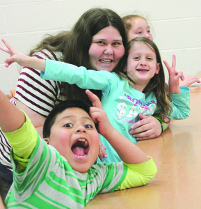 Katie Brandl, left, with C4K second-grade students Misael Enriquez and Makinley Bryant. Photo by Sarah Colson