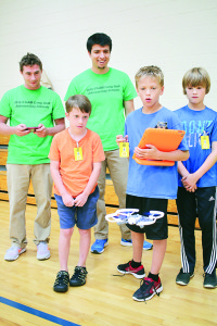 Drone operators: Students Bryson Wilhjelm, Brady Vermillion and Aidyn Peterson watch, along with graduate education student Caz Razo, as graduate student Cory Fain operates a drone.