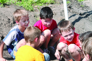 Adam Alkhateeb, Braden Miller and Grayson Smithson (l-r facing camera) enjoy the dig site with some classmates.
