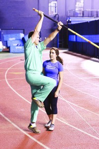 University High coach Alan Cox explains a finer point to sophomore vaulter Julia Gabel. Photo by Jeff Keeling