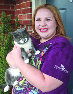 Kylie Kellogg with ‘Caly,’ one of seven cats and three puppies she’s currently fostering at her home. Photo by Jeff Keeling