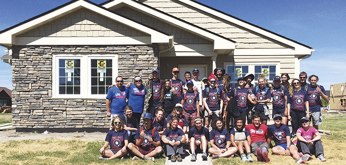 Jennifer and EJ, back left, with the Bike & Build team (O’Leary is front left) in front of their under-construction home.