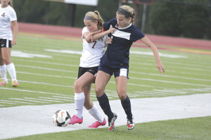 Senior midfielder Emily Fabel, left, tangles with a Jefferson County player near the sideline. Photos by Robert Kell creativestoryvisuals.com