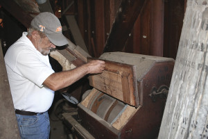 Baker inspects on of many pieces of milling equipment that remain inside the structure. Photo by Jeff Keeling