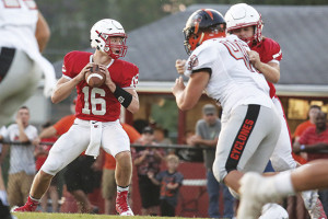 Starting quarterback Noah Shelton, who left the game with an injury, looks for a receiver in the first quarter.