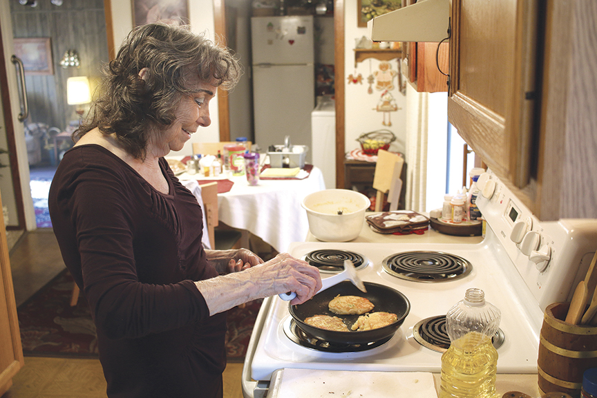 Ellie Chestnut fries up some of her special hush puppies for the folks at Johnson City Internal Medicine. Photo by Jeff Keeling