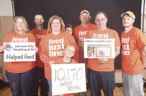 Volunteers from Johnson City Heating and Air, which packed the most boxes, included Angela Lay, Austin Hughes, Kellie Ritsko, Peggy Lanzon, Ed Ritsko, Tim Ricker, TJ Laney and (holding sign) Ella Grace Ritsko. Photos by Dutch Lloyd