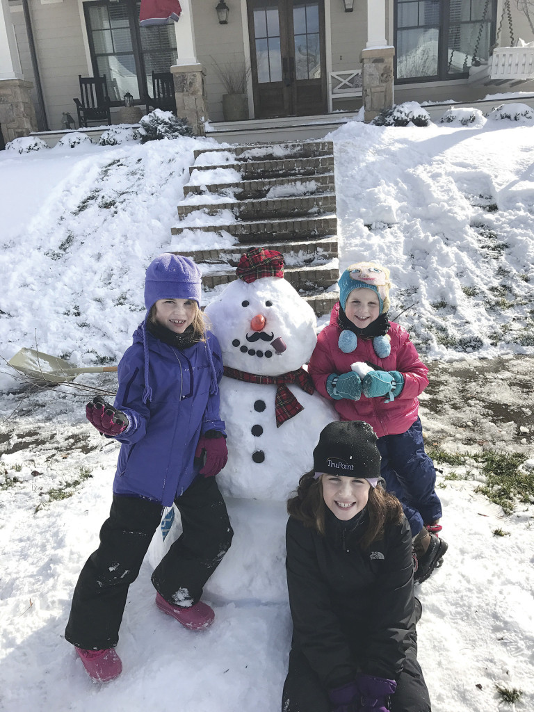 Piper Hixson, Campbell Hixson and Maeve Hixson with their snowman. Photo by Clay Hixson