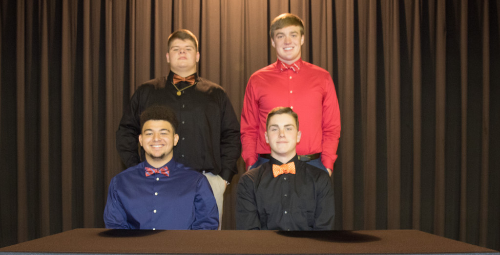 Daniel Boone's Justin Turner and Justin Clark, back row, along with Ethan Harrell and Ian Weir signed with their colleges on Friday.