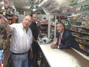 Governor Bill Haslam listens as Sonny Fletcher points to a picture of his father behind the counter of his store in Stoney Creek. John Fletcher (middle) looks on. Photo by Scott Robertson