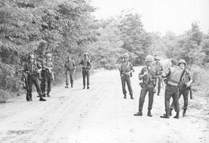 Soldiers from the 2nd Infantry Division on DMZ patrol emerge from waist-deep water with loaded M-14 weapons. Photo by Bill Derby