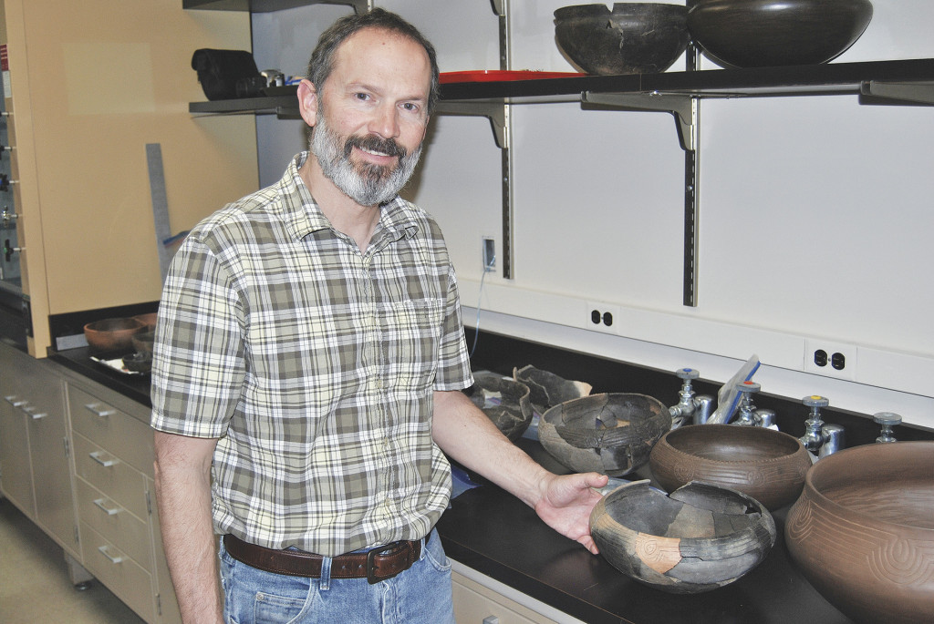 ETSU professor Dr. Jay Franklin with some of the pottery discovered during a dig at the 12-acre Cane Notch site along the shore of the Nolichucky River during the winter of 2015-16. PHOTO BY DAVE ONGIE