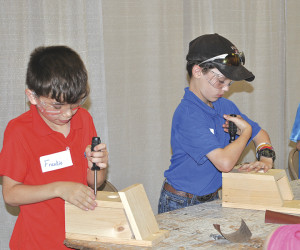 A couple young men work to complete their bird houses. The projects completed at Thursday's event could be entered into the upcoming Appalachian Fair.
