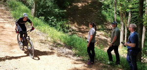 Walton Family Foundation Program Officer Gary Vernon shows local officials around the Coler Mountain Preserve bike trail.