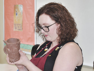 Liberty Bell art teacher Brooke Velsor demonstrates a technique to students during an Art Transforms class at the school. PHOTOS BY DAVE ONGIE