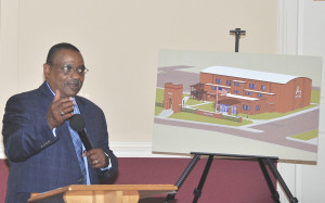 Michael Young gestures toward the rendering of the historic Langston building, which will be transformed into a multicultural center. PHOTOS BY DAVE ONGIE