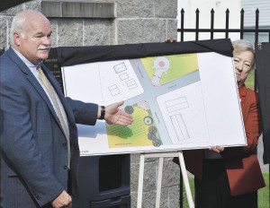 Randy Reeves, the Under Secretary for Memorial Affairs, and Jeny Walker, director of the Mountain Home National Cemetery, unveil a rendering of the new archway that will be added to the VA cemetery in the coming months. PHOTO BY DAVE ONGIE