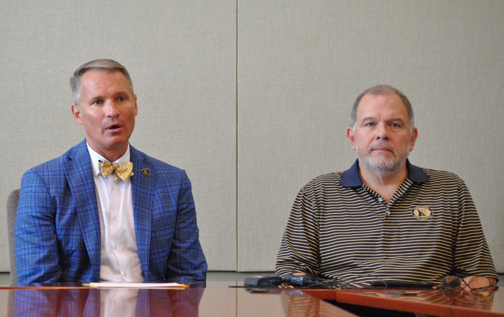 ETSU president Dr. Brian Noland (left) and Johnson City city manager Pete Peterson discuss the details of an agreement that will result in the university purchasing the Millennium Center from the city's Public Building Authority. PHOTO BY DAVE ONGIE