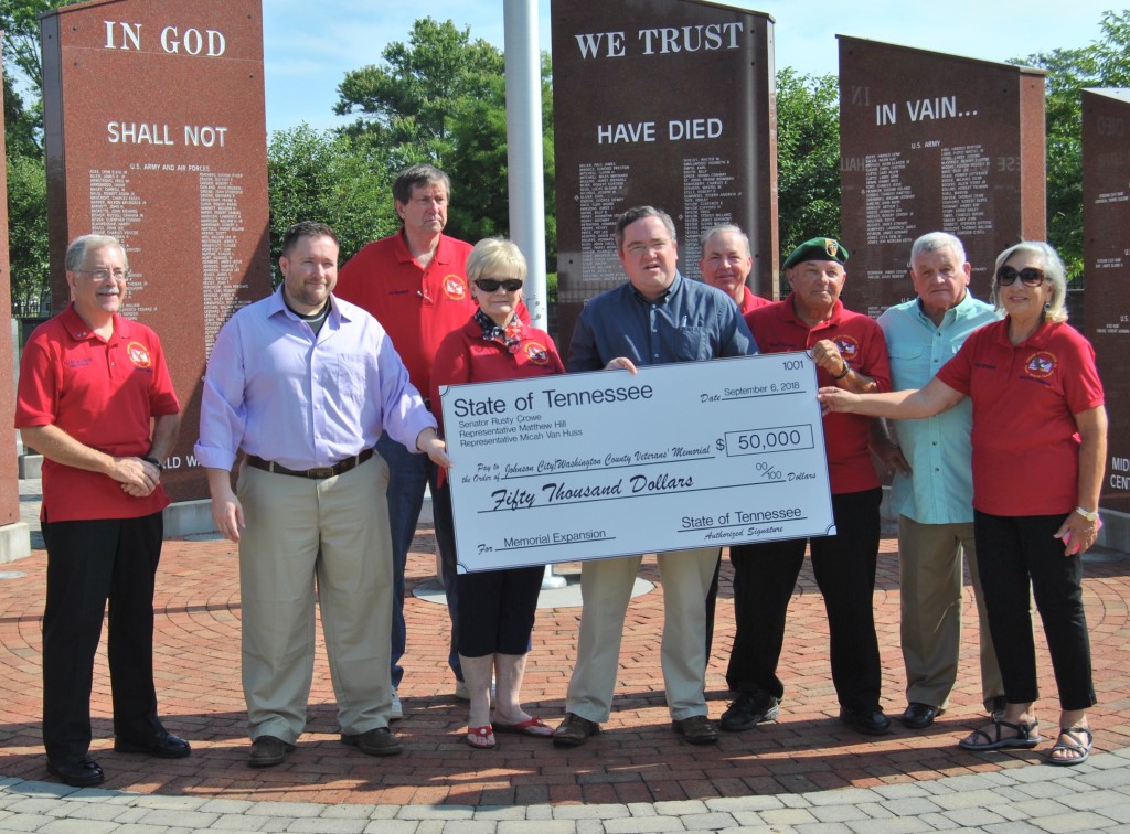 State Representatives Matthew Hill (center) and Micah Van Huss (second from left) present a check for $50,000 on behalf of the State of Tennessee to members of the Veterans Memorial Executive Committee. PHOTO BY DAVE ONGIE