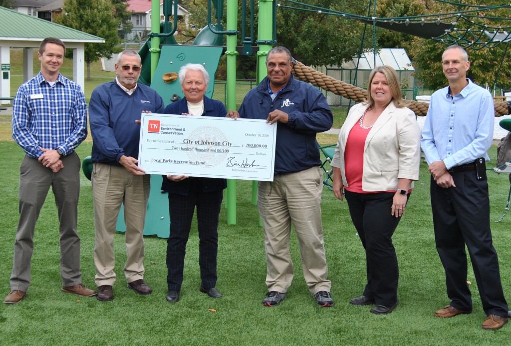 Johnson City vice-mayor Jenny Brock and Herb Greenlee, supervisor of the Carver Recreation Center, receive a $200,000 check from representatives of the Recreation Services Division of the Tennessee Department of Environment and Conservation. The money will go toward a new splash pad at Carver. PHOTO BY DAVE ONGIE