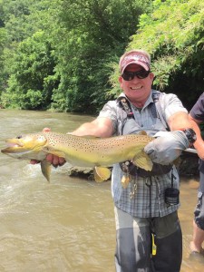 A Project Healing Waters participant shows off a monster brown trout he pulled out of the Watauga River during a recent event at Camp Stonefly. Gee, who works in the fast-paced world of finance back home in Charlotte, allows local veterans to use his camp. CONTRIBUTED