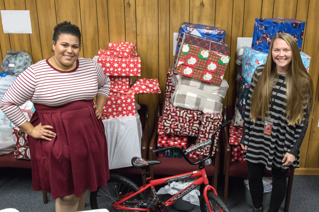 Sydnee DeBusk (right), coordinator of the Homeless Education Program for the Johnson City School system and program assistant Shaneice Austin with some of the presents that have been donated to homeless students in the Johnson City School System. PHOTO BY COLLIN BROOKS